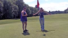 Beth and Georgia miming on a golf course