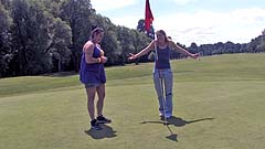 Beth and Georgia miming on a golf course