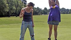 Beth and Georgia miming on a golf course