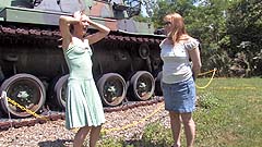 Vicktoria and Georgia wetting panties by an Army tank