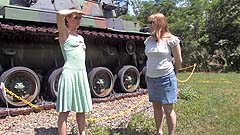 Vicktoria and Georgia wetting panties by an Army tank