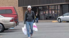 Mela walking to her car with her shopping bags