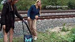 Kathy and Lindsay peeing by a railway track